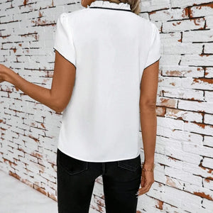 Blus med svart rosett